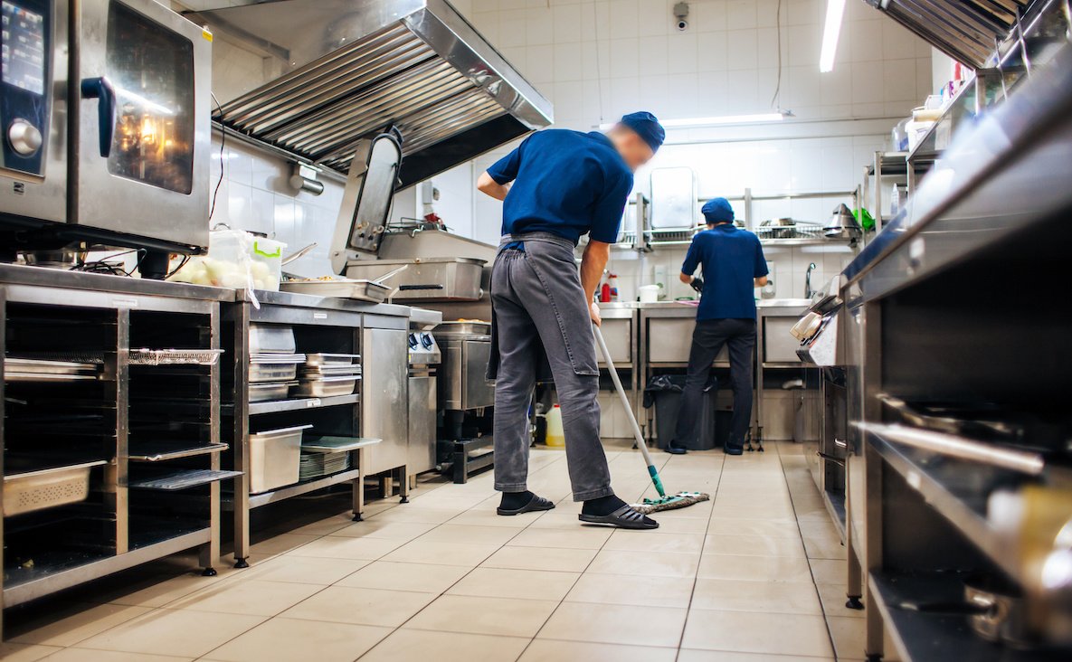 assistant cleans in the kitchen